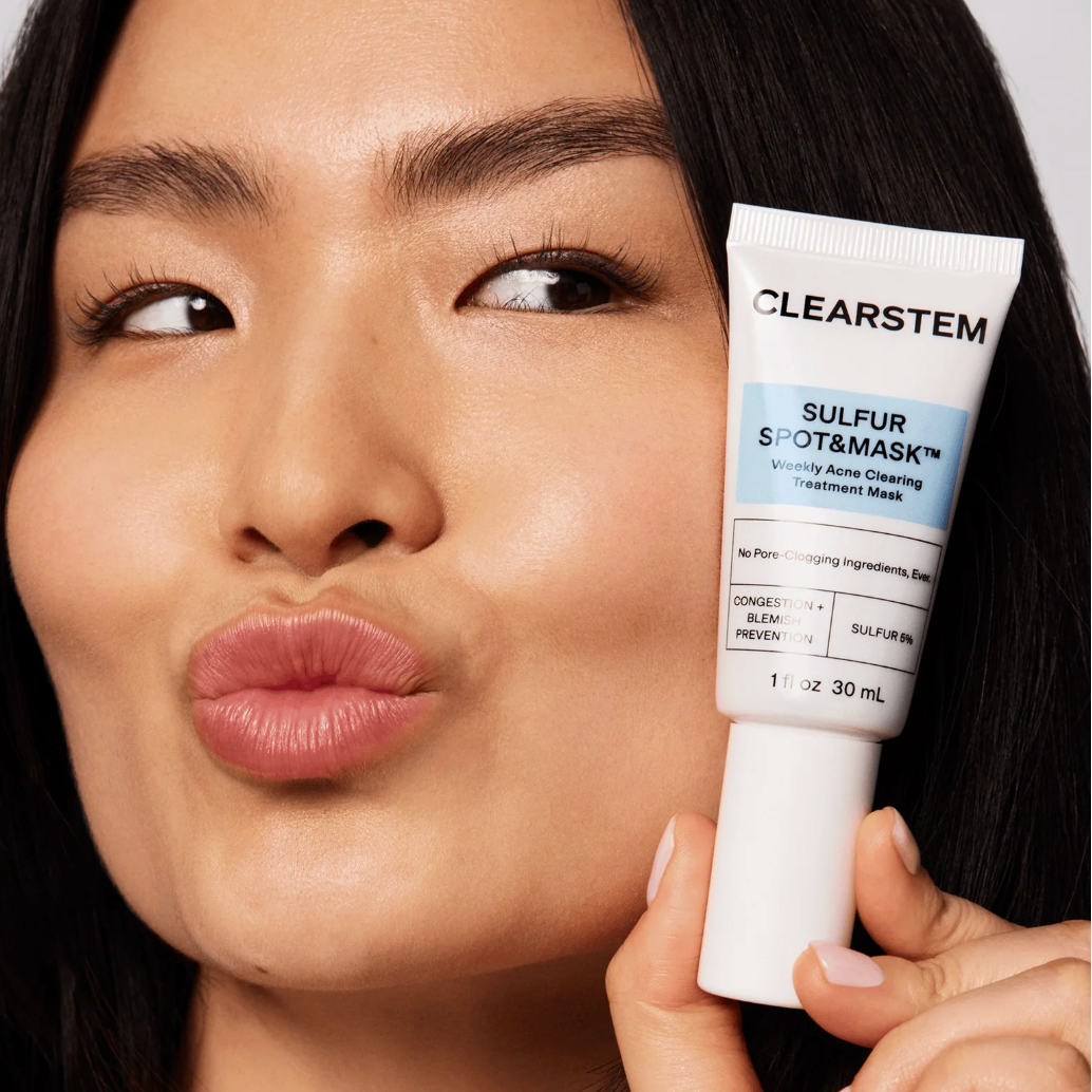 Woman holding a Clearstem sulfur spot and mask tube close to her face
