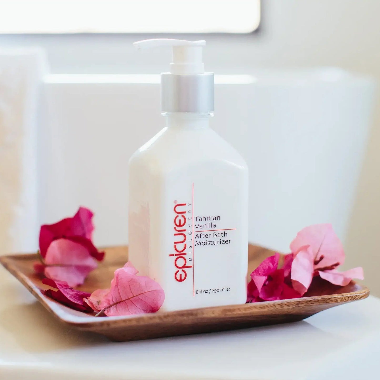 Epicuren After Bath Moisturizer bottle on a tray with pink flowers