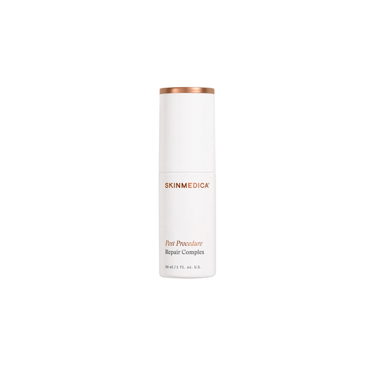 A white cylindrical skincare bottle with a metallic rose gold cap, labeled 'SKINMEDICA Post Procedure Repair Complex', on a clean white background.