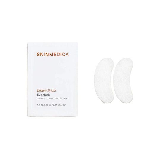 Skinmedica Instant Bright Eye Mask packaging next to two white crescent-shaped eye mask patches on a light beige background.