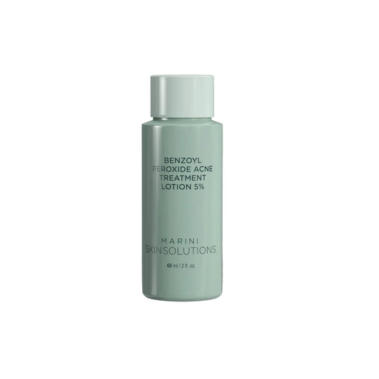 Green bottle of benzoyl peroxide 5% acne treatment lotion on a white background
