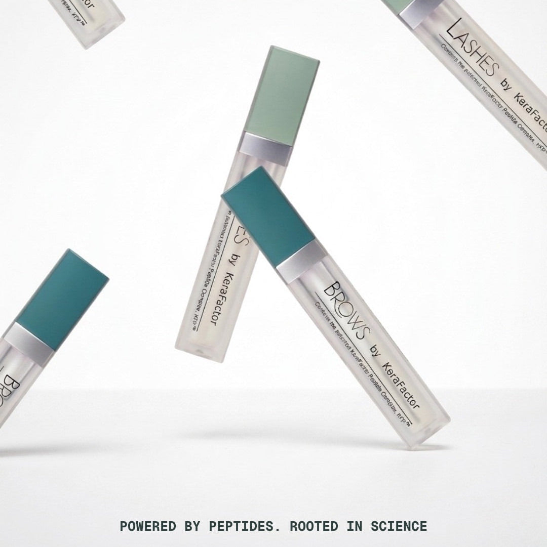 Five tubes KeraFactor Lashes & Brows Professional product are arranged diagonally on a clean white background, featuring teal caps and clear bodies showing the white product inside. Text at the bottom reads 'POWERED BY PEPTIDES.