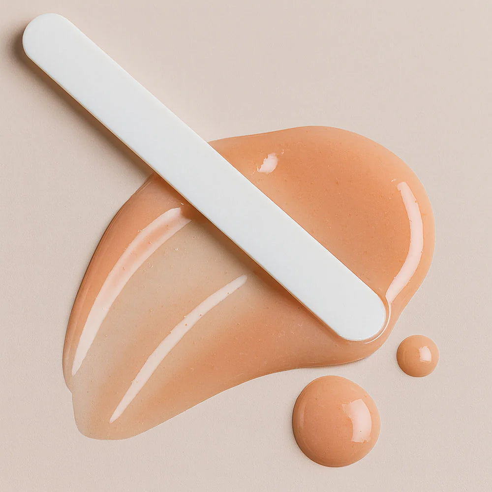 Beige cream with a spatula on a beige background