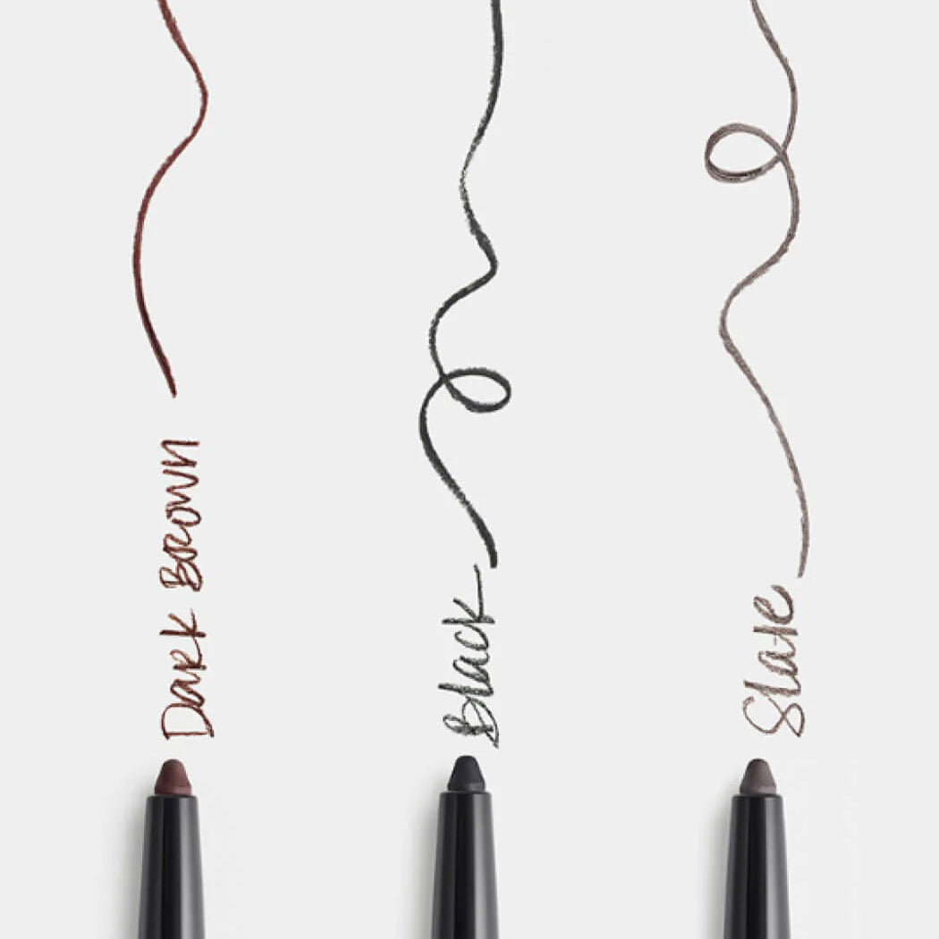 Three eyeliner pencils with colored tips on a white background