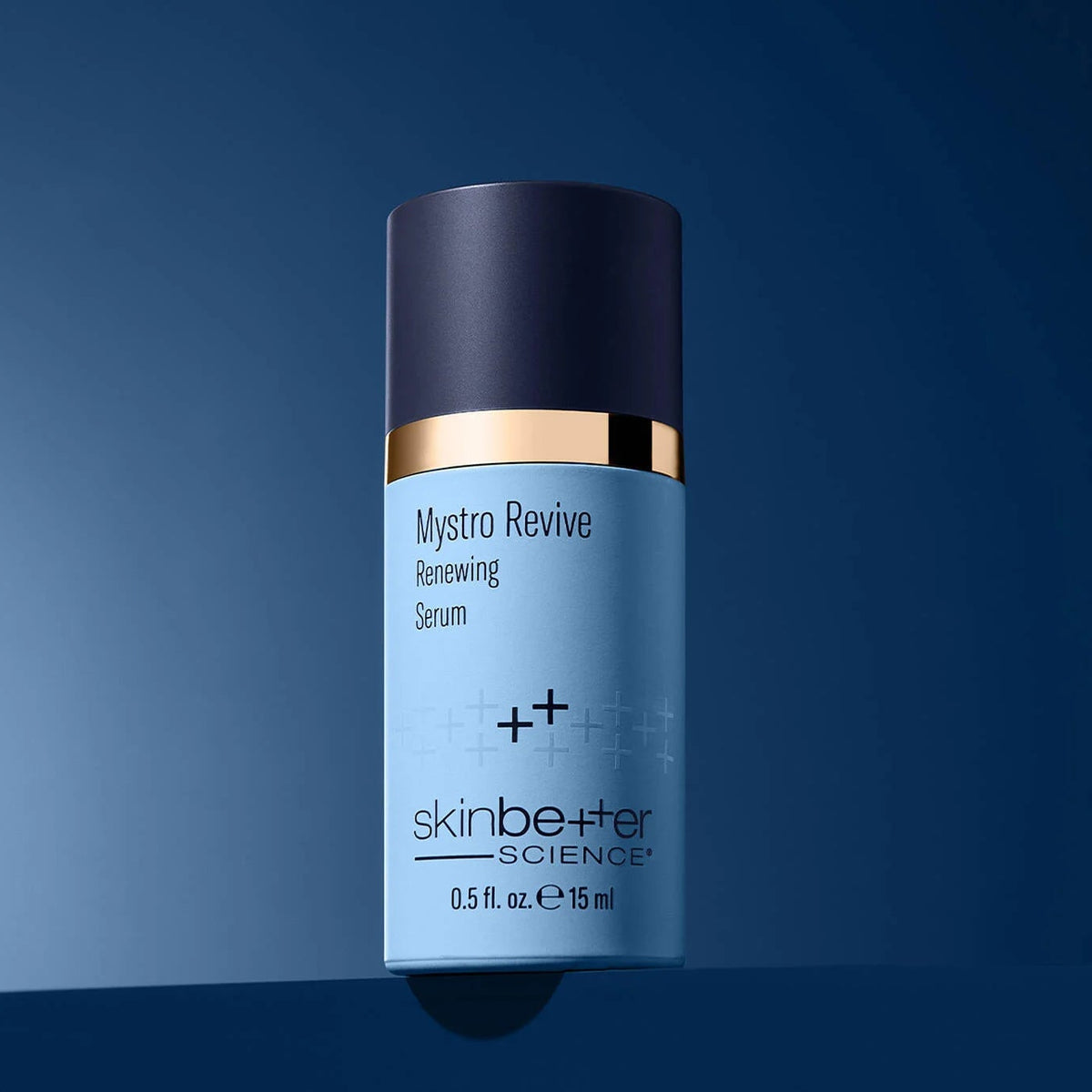 Blue skincare serum bottle with gold accents on a blue background