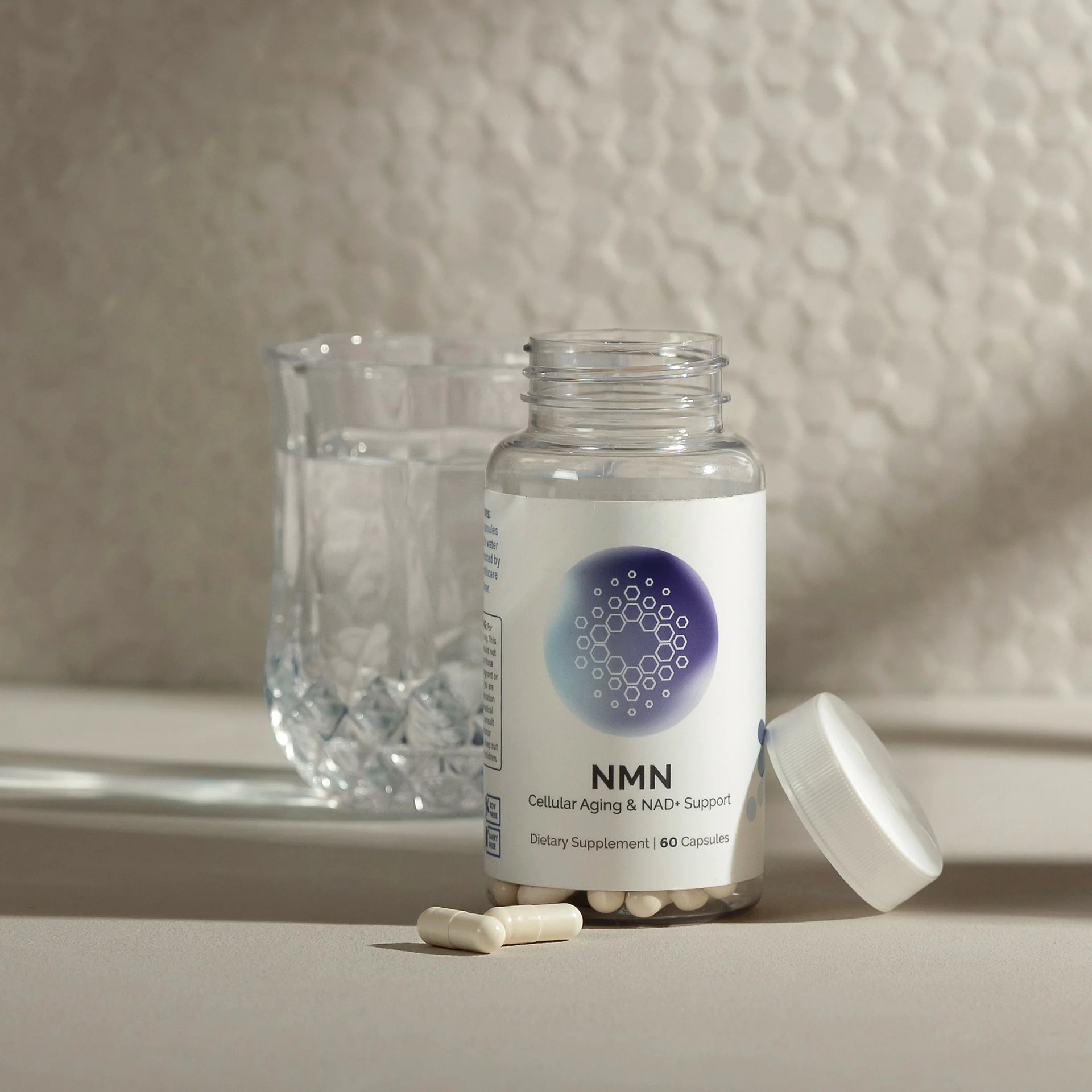 NMN supplement bottle with capsules on a neutral background