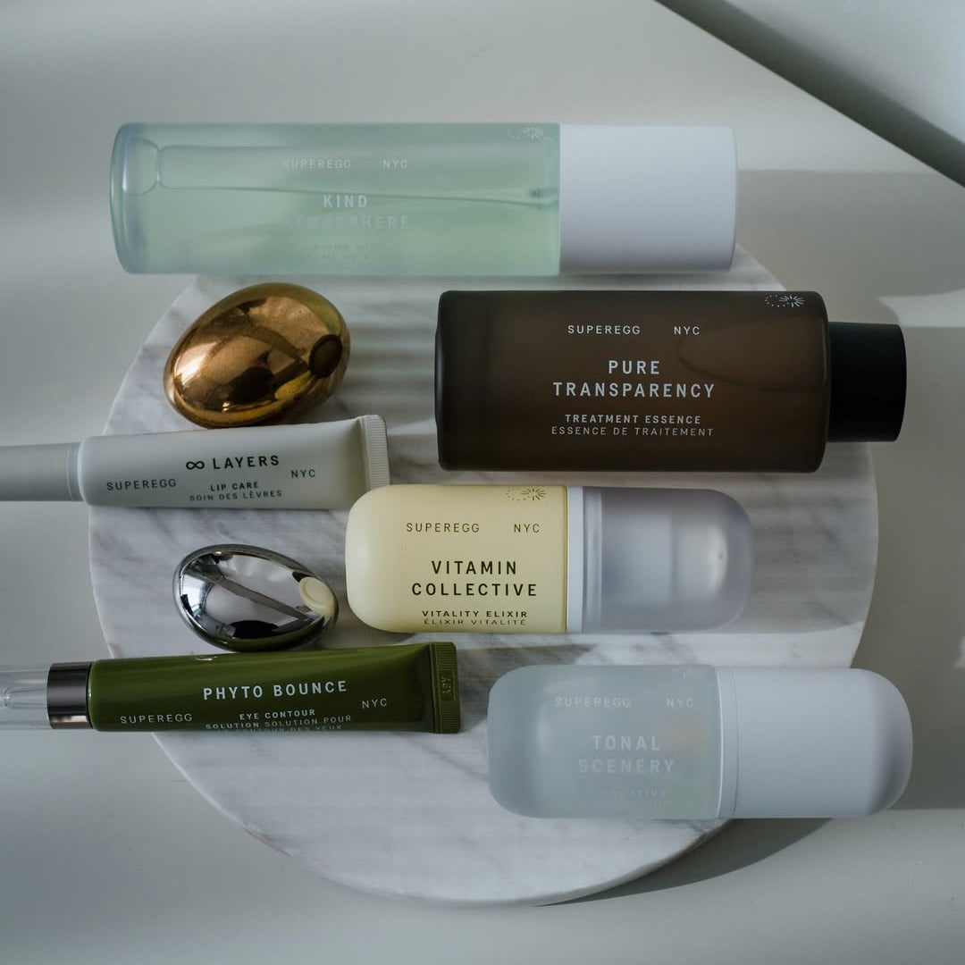 Collection of skincare products on a white marble surface with a neutral background. Introducting Superegg to Skin Truth