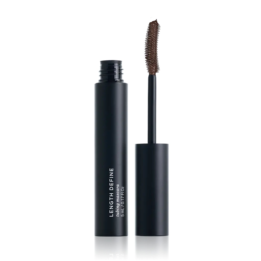 A black cosmetic tube labeled 'LENGTH DEFINE' stands open next to its applicator wand on a clean white background.