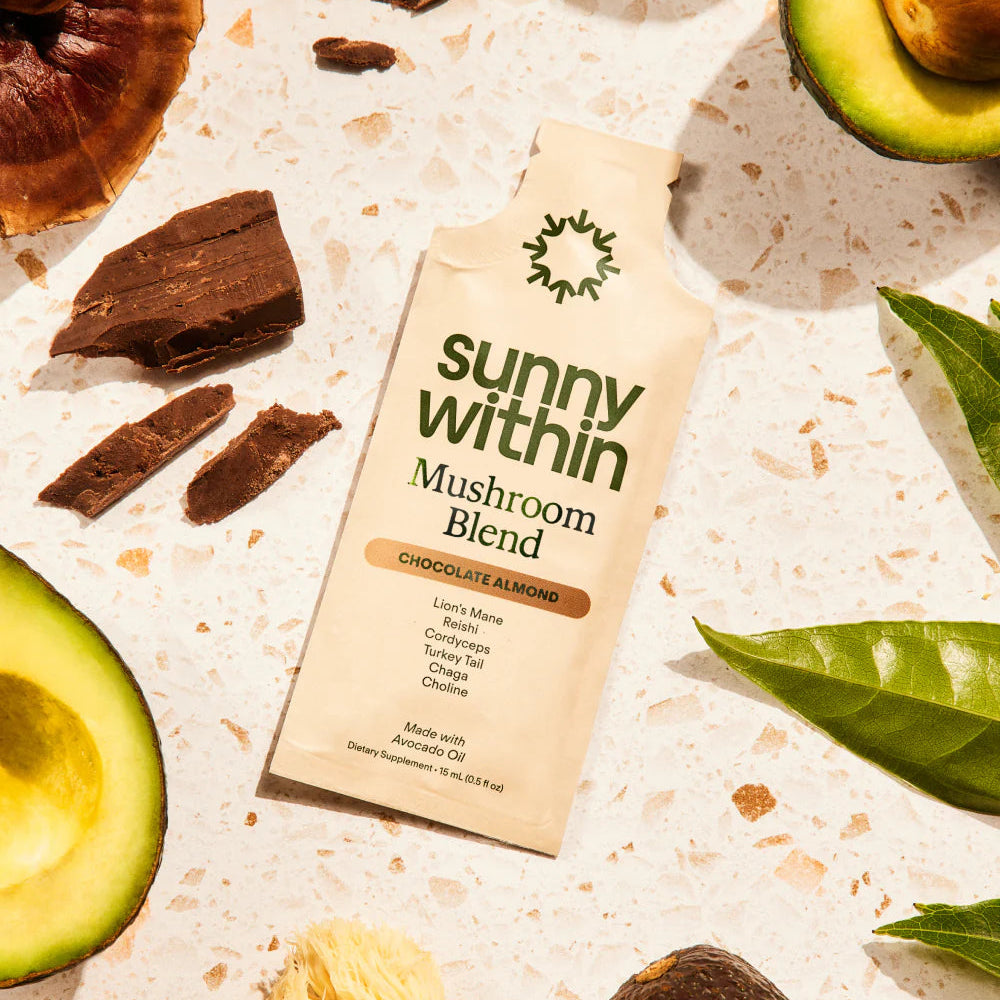 Sunny Within Mushroom Blend package with avocados, mushrooms, and leaves on a textured surface
