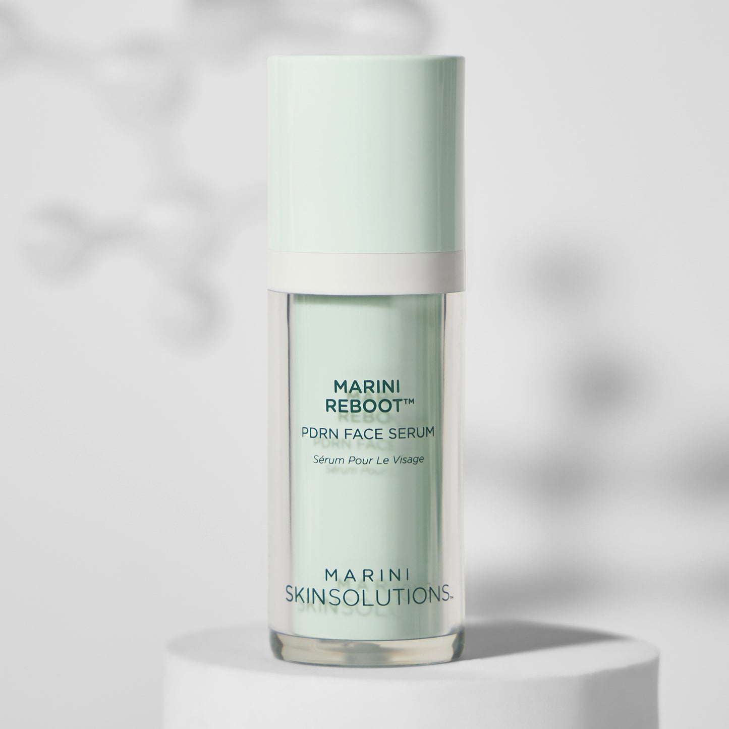 Skincare serum bottle labeled 'Marini Reboot' on a light background