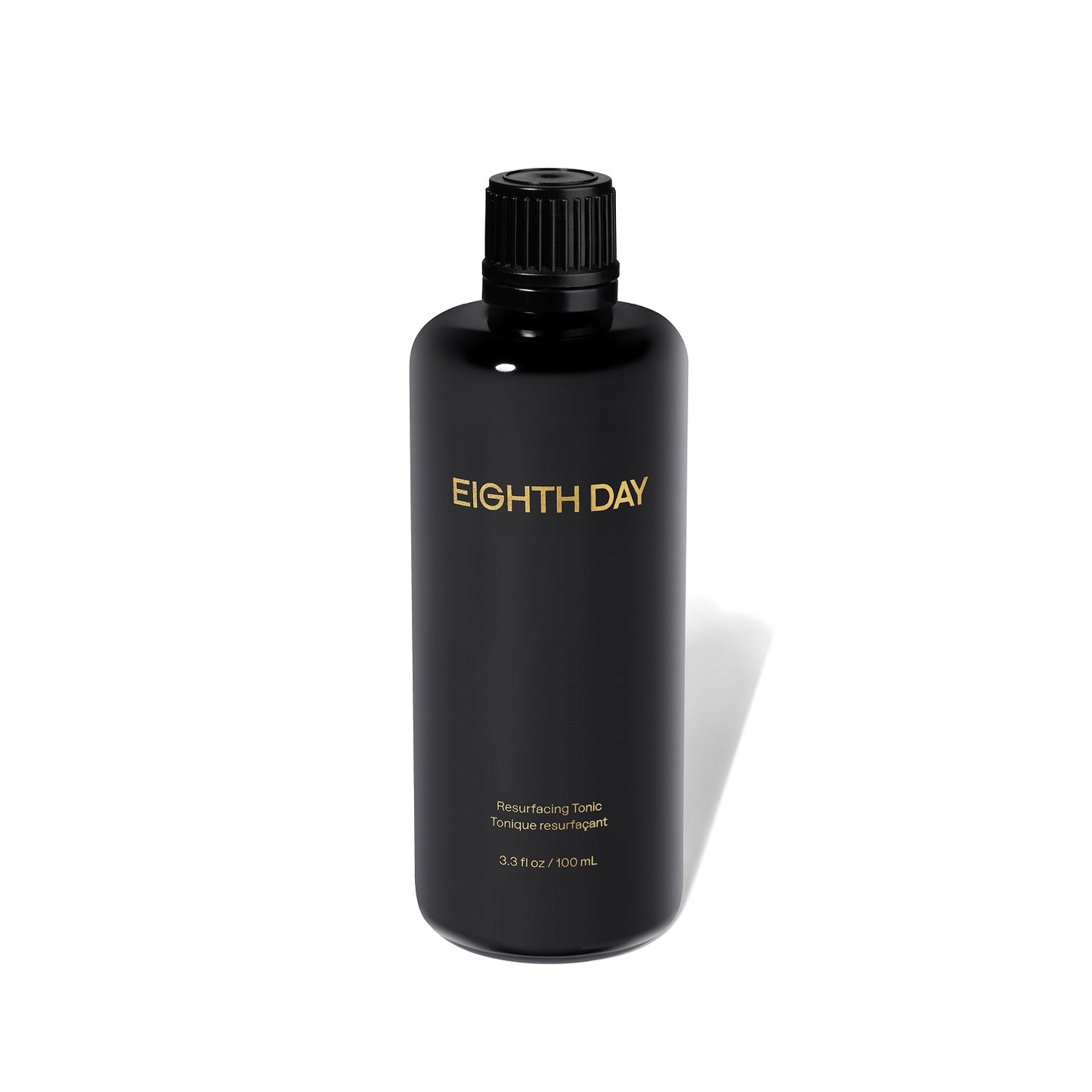 Black bottle of Eighth Day product on a white background