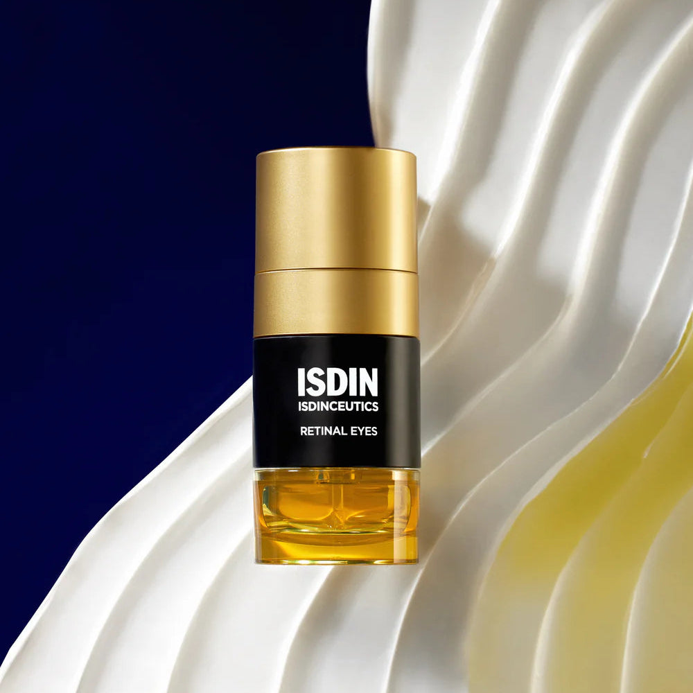 ISDIN skincare bottle with gold cap on a wavy white and blue background