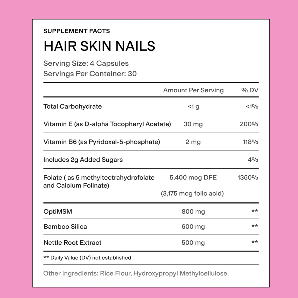 Supplement facts label for hair, skin, and nails on a pink background