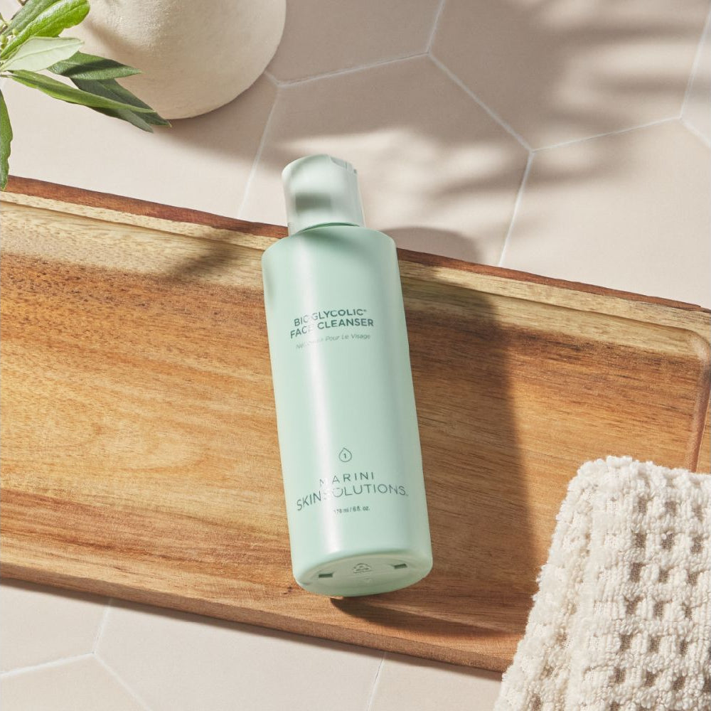 Skincare bottle on a wooden tray with a neutral background