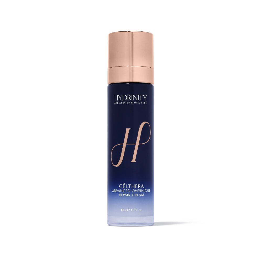 Hydrinity Célthera Advanced Enrichment Repair Cream in a 50 ml bottle. The bottle is dark blue with a metallic rose gold cap and features a large stylized 'H' logo on the front.