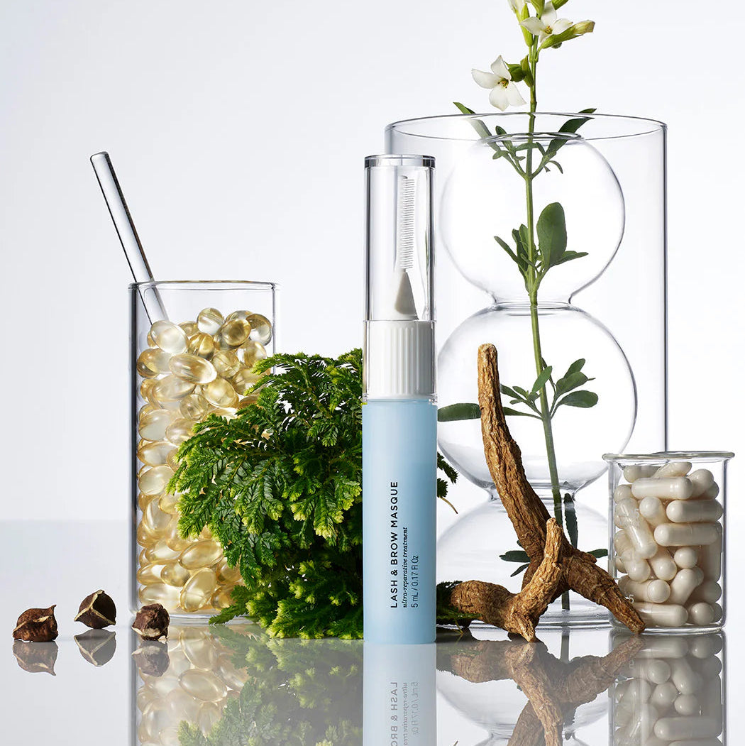 Skincare product with natural elements on a reflective surface