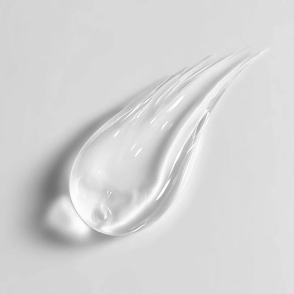 Clear gel or cream with a teardrop shape on a light gray background